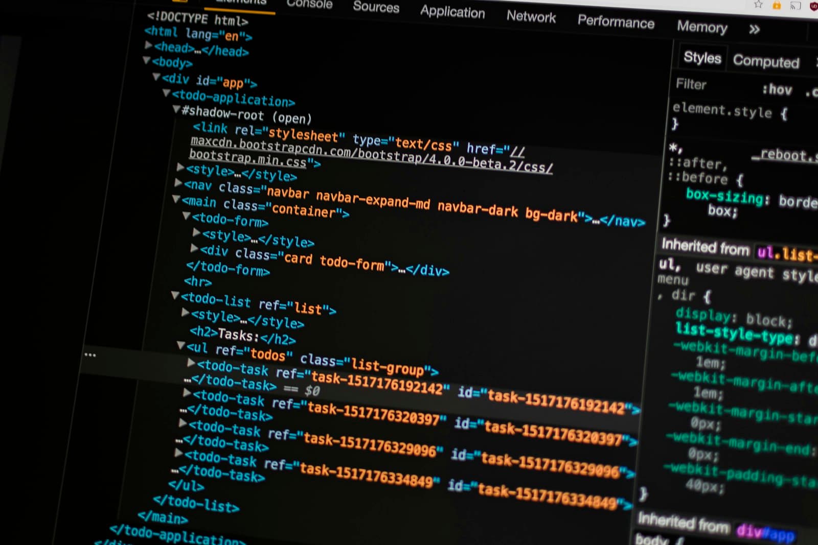 Developer writing website code on a laptop